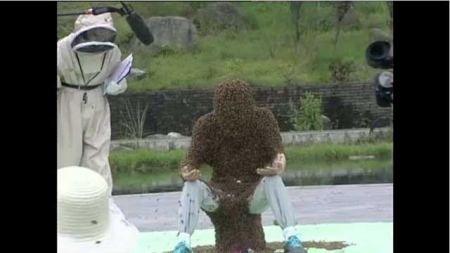 فيديو : نحال من الصين يقف لمدة 53 دقيقة متغطياً بالنحل !